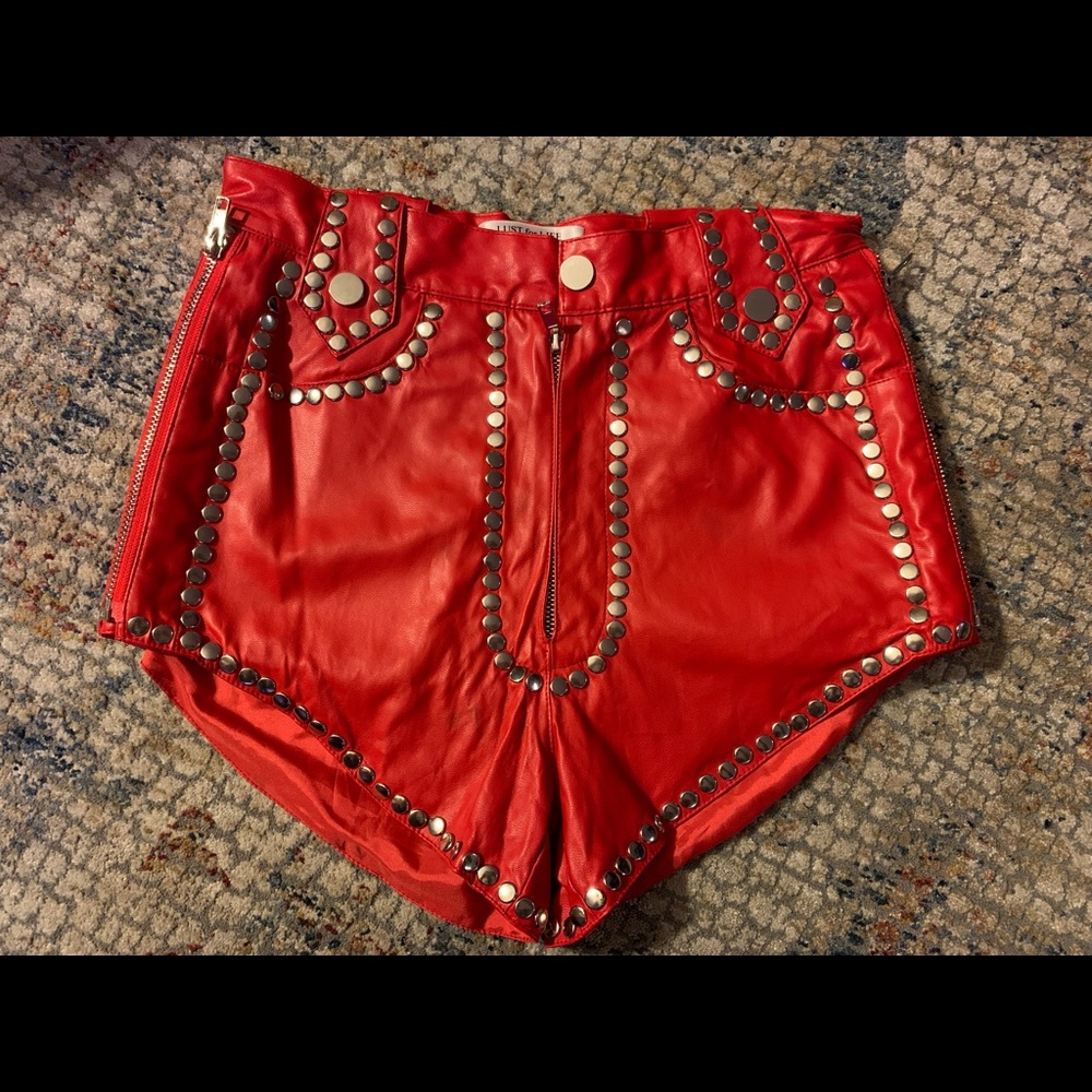 Red faux leather mini shorts with silver studs